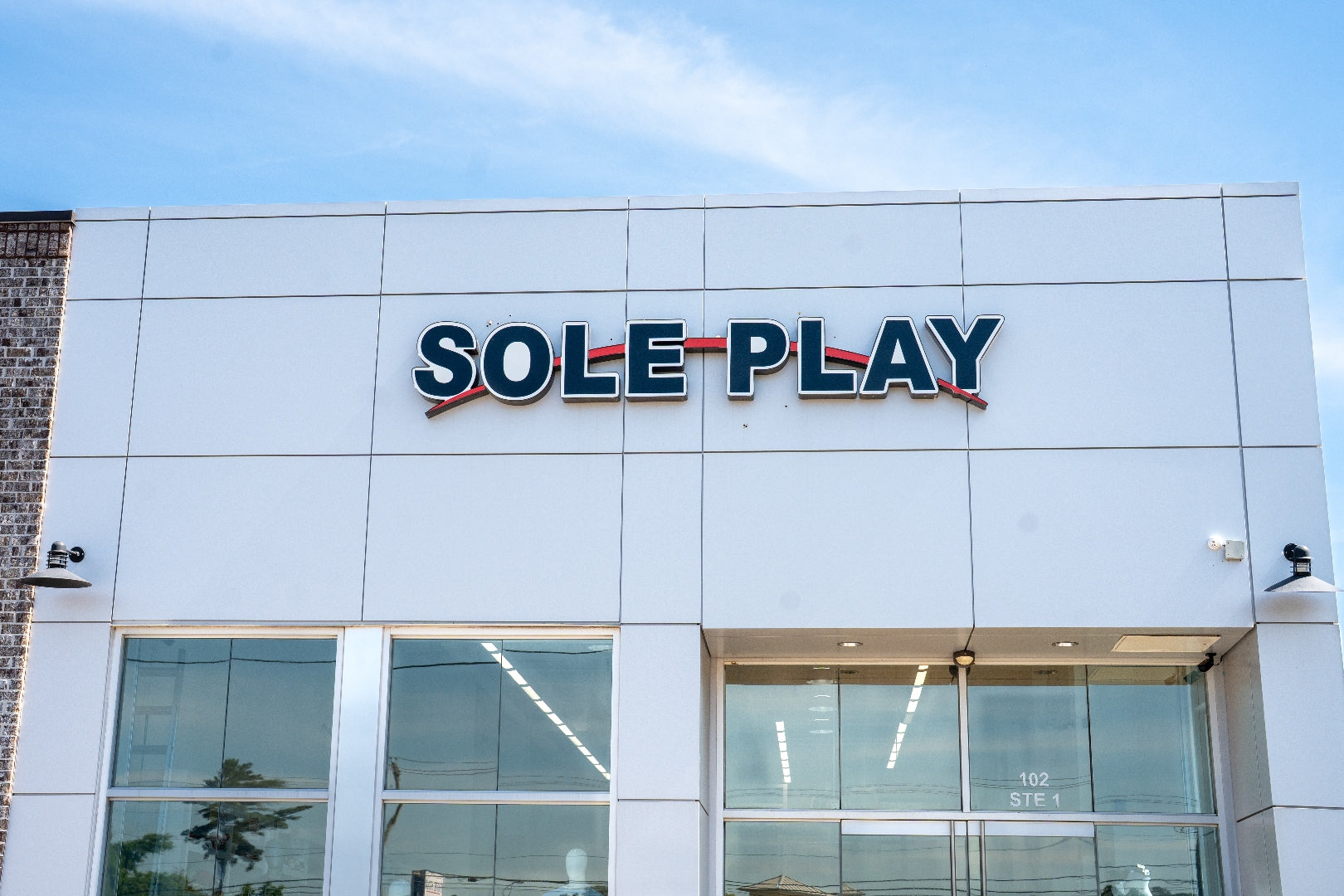 Sole Play Bama exterior signage close-up against blue sky