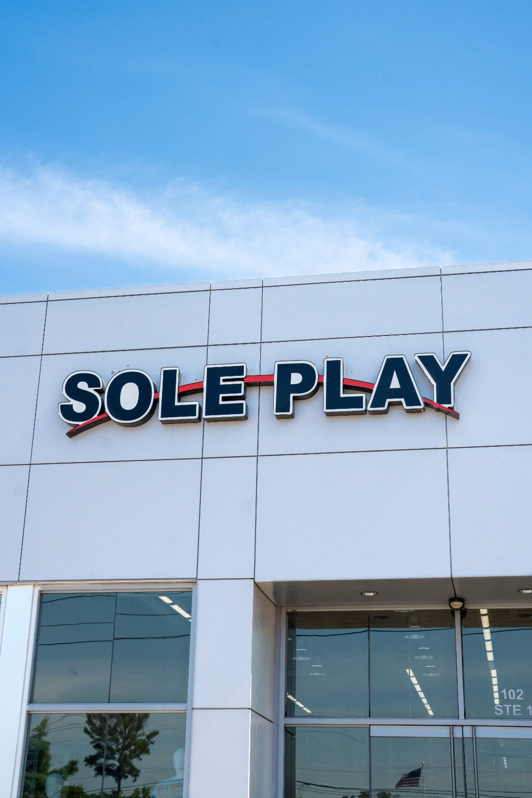 Sole Play Bama signage vertical close-up against blue sky