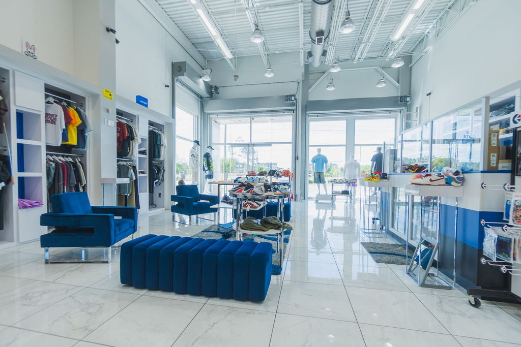 Sole Play Bama interior — lounge area with sneaker tables and apparel