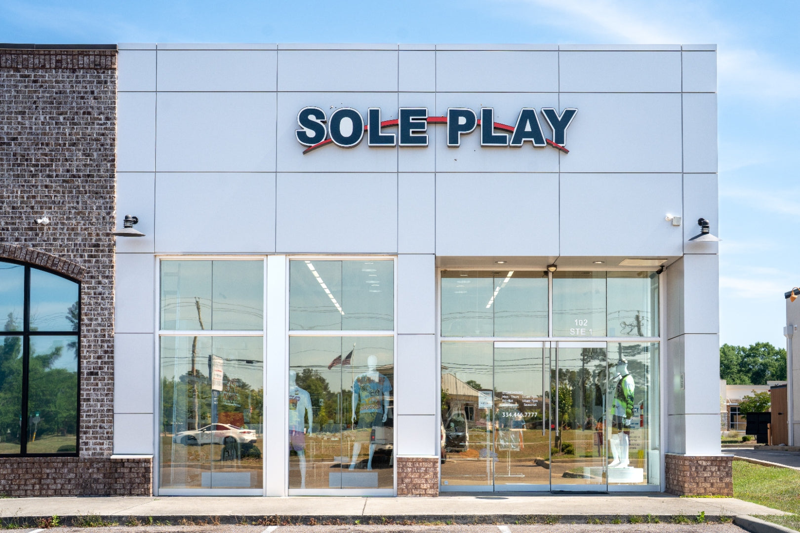 Sole Play Bama storefront — wide front view with brick neighbor